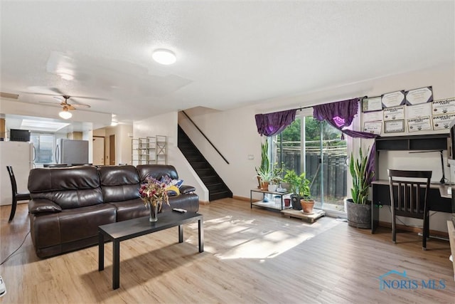 2540 Plum Leaf Ln, Toledo, OH 43614 - living area with wood finished floors, stairway, baseboards, and ceiling fan