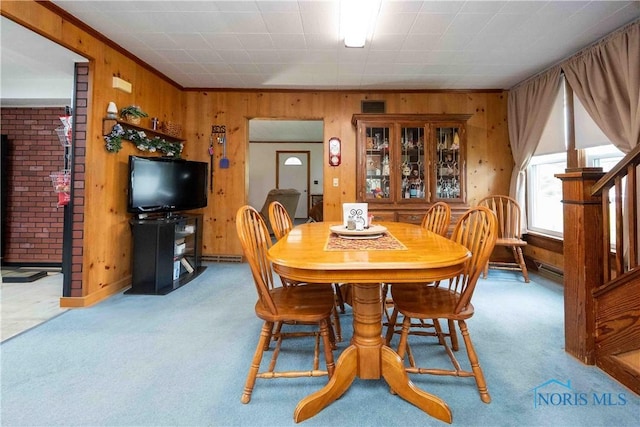 344 E Findlay St, Sugar Creek Township, OH 45893 - dining room with wood walls, carpet flooring, and stairs