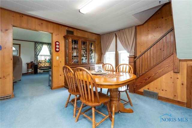 344 E Findlay St, Sugar Creek Township, OH 45893 - carpeted dining space featuring wood walls and stairway