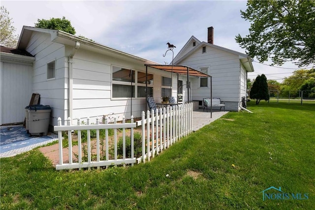 344 E Findlay St, Sugar Creek Township, OH 45893 - back of property featuring a patio and a chimney