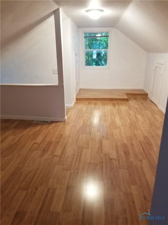 5502 Rudyard Rd, Sylvania, OH 43560 - additional living space with wood finished floors, lofted ceiling, and baseboards
