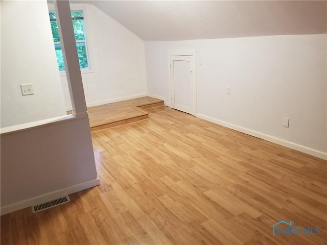 5502 Rudyard Rd, Sylvania, OH 43560 - additional living space featuring lofted ceiling, baseboards, and light wood-style floors
