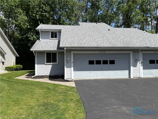 6955 Dorr St Unit 56, Toledo, OH 43615 - view of front of home with a shingled roof, asphalt driveway, an attached garage, and a front yard