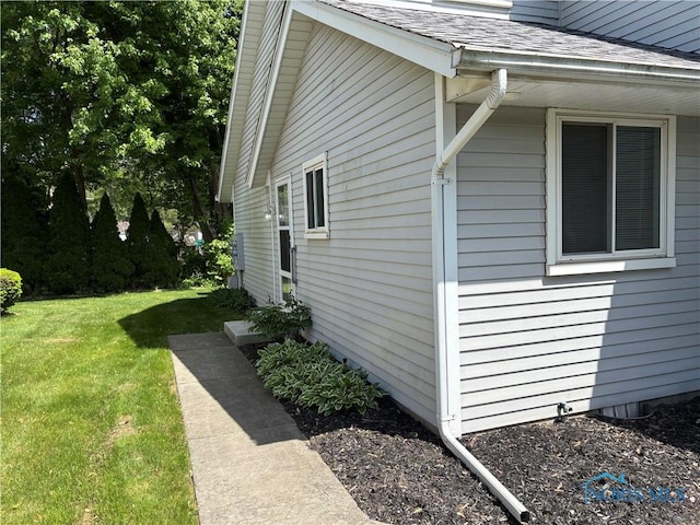 6955 Dorr St Unit 56, Toledo, OH 43615 - view of property exterior featuring a lawn and roof with shingles