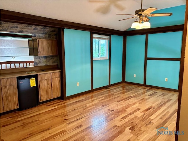 6955 Dorr St Unit 56, Toledo, OH 43615 - interior space featuring light wood-style flooring, ceiling fan, baseboards, and vaulted ceiling