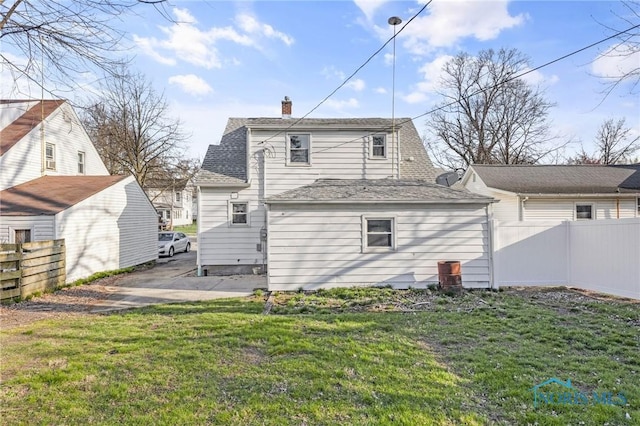 259 W Elm St, Wauseon, OH 43567 - rear view of house with a chimney and roof with shingles