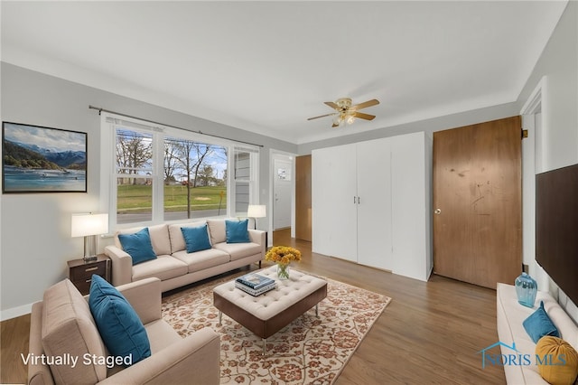 259 W Elm St, Wauseon, OH 43567 - living area featuring a ceiling fan and wood finished floors