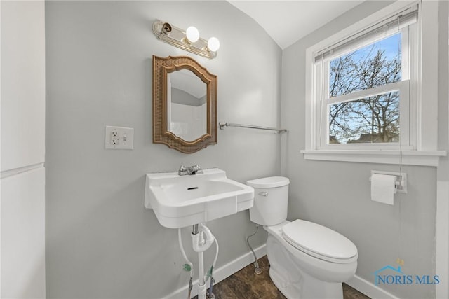 259 W Elm St, Wauseon, OH 43567 - half bath featuring baseboards, toilet, and vaulted ceiling
