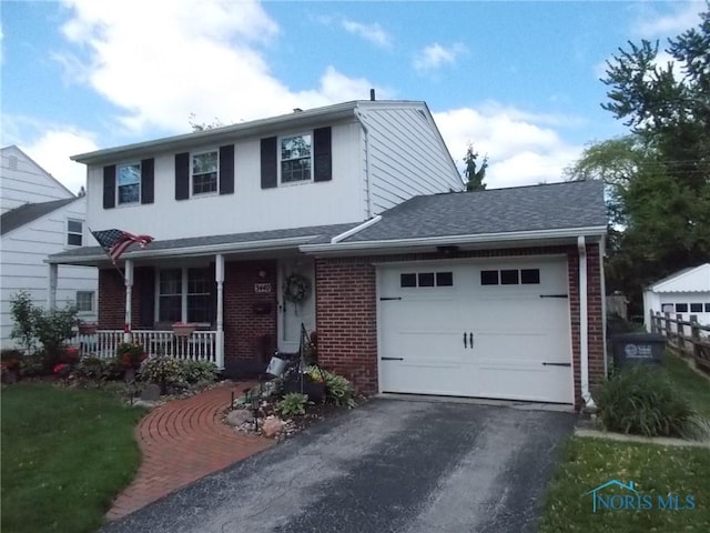 3440 Mapleway Dr, Toledo, OH 43614 - view of front facade featuring driveway, a porch, brick siding, and a garage