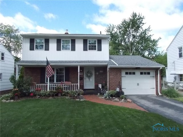 3440 Mapleway Dr, Toledo, OH 43614 - traditional home featuring an attached garage, brick siding, driveway, and a porch