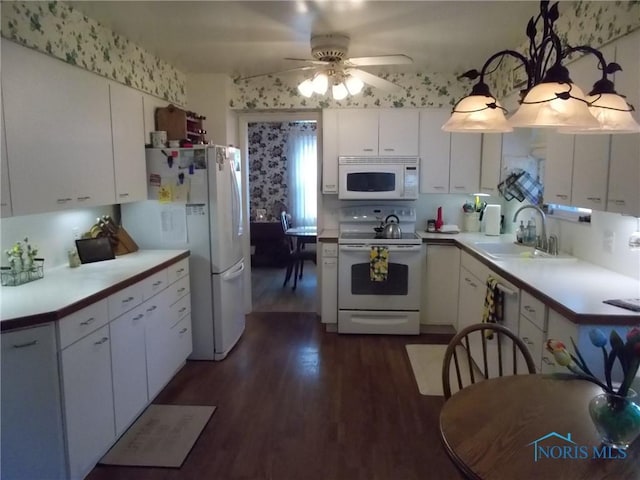 3440 Mapleway Dr, Toledo, OH 43614 - kitchen with white appliances, a sink, dark wood-style flooring, white cabinetry, and a ceiling fan