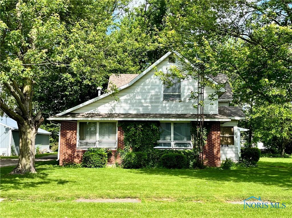320 S Keyser Ave, Deshler, OH 43516 - view of front of home with a front lawn and brick siding