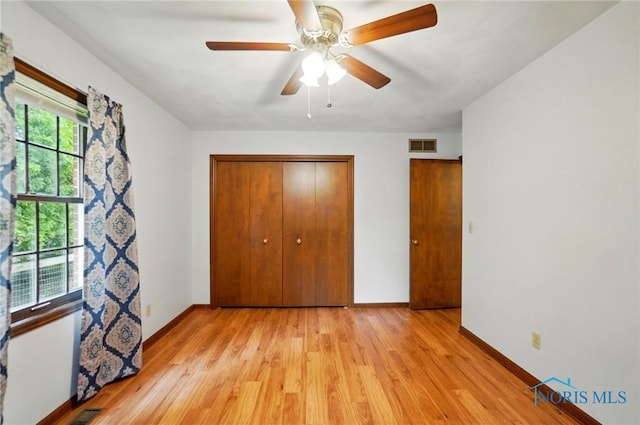 1110 Bourgogne Ave, Bowling Green, OH 43402 - unfurnished bedroom with light wood-type flooring, a closet, baseboards, and a ceiling fan