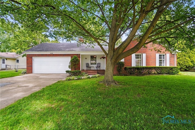 1110 Bourgogne Ave, Bowling Green, OH 43402 - ranch-style home with brick siding, a front lawn, and a garage