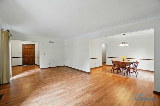1110 Bourgogne Ave, Bowling Green, OH 43402 - living room featuring light wood-type flooring, a chandelier, crown molding, and baseboards