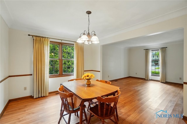 1110 Bourgogne Ave, Bowling Green, OH 43402 - dining room with a chandelier, light wood-type flooring, baseboards, and crown molding