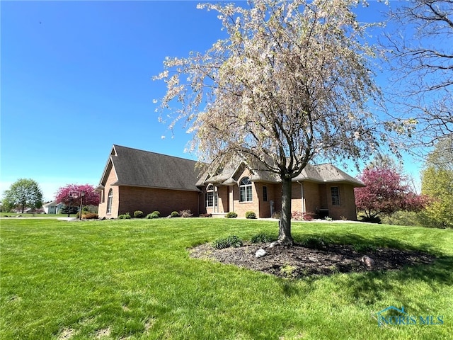 5506 Brookview Ln, Upper Sandusky, OH 43351 - view of front of home with brick siding and a front lawn