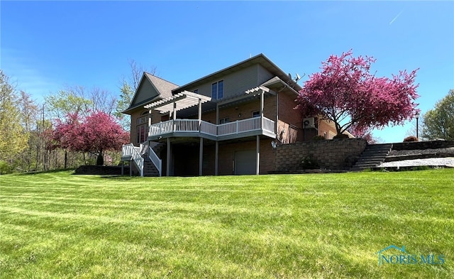 5506 Brookview Ln, Upper Sandusky, OH 43351 - rear view of house featuring stairway, a garage, a wooden deck, a lawn, and brick siding