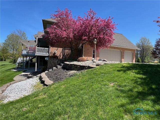 5506 Brookview Ln, Upper Sandusky, OH 43351 - view of front of property featuring an attached garage, stairway, brick siding, a front yard, and a wooden deck