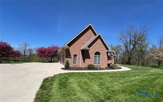 5506 Brookview Ln, Upper Sandusky, OH 43351 - single story home featuring concrete driveway, brick siding, a front yard, and a garage