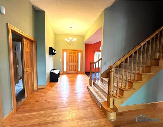 5506 Brookview Ln, Upper Sandusky, OH 43351 - entrance foyer with wood finished floors, a chandelier, stairs, and baseboards