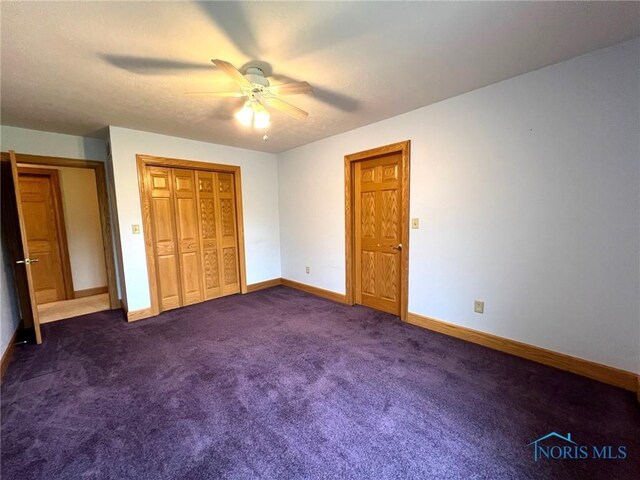 5506 Brookview Ln, Upper Sandusky, OH 43351 - unfurnished bedroom with baseboards, dark colored carpet, and a ceiling fan