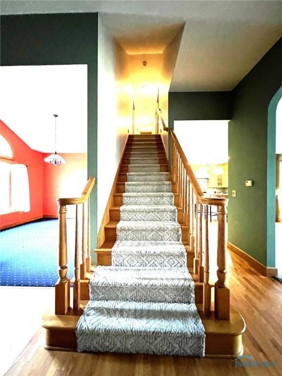 5506 Brookview Ln, Upper Sandusky, OH 43351 - stairway with arched walkways, wood finished floors, and baseboards