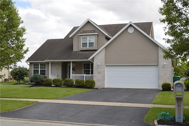 1243 1st St, Findlay, OH 45840 - traditional home featuring brick siding, asphalt driveway, a porch, a front lawn, and a shingled roof