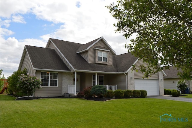 1243 1st St, Findlay, OH 45840 - view of front of house with covered porch, asphalt driveway, a front yard, and brick siding