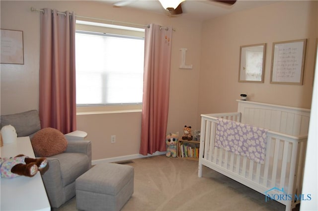 1243 1st St, Findlay, OH 45840 - bedroom with a crib, carpet, and ceiling fan