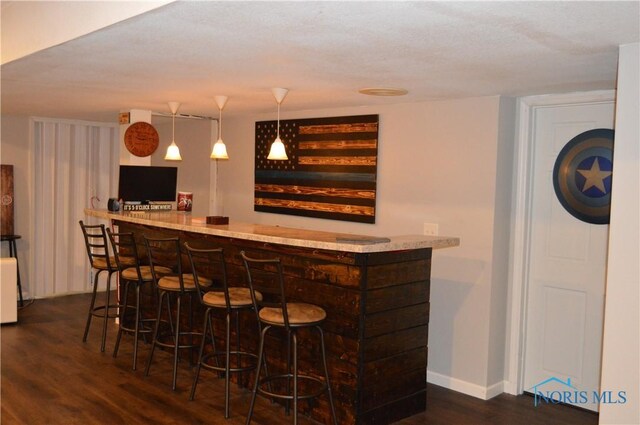 1243 1st St, Findlay, OH 45840 - indoor dry bar featuring wood finished floors, baseboards, and hanging light fixtures