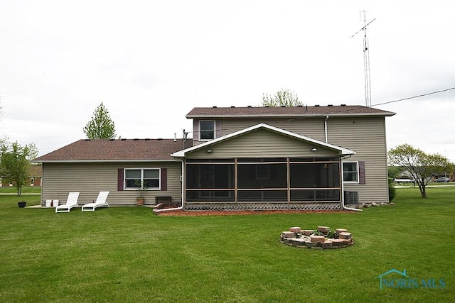 100 E End Dr, Pioneer, OH 43554 - back of house with an outdoor fire pit, a sunroom, a lawn, and central air condition unit