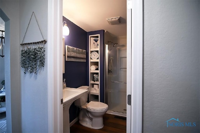 100 E End Dr, Pioneer, OH 43554 - full bathroom with a shower stall, toilet, wood finished floors, and a textured wall