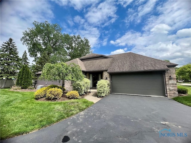 2946 Glaston Oaks Ct Unit 2946, Toledo, OH 43617 - view of front of home with driveway, a front yard, a garage, roof with shingles, and brick siding