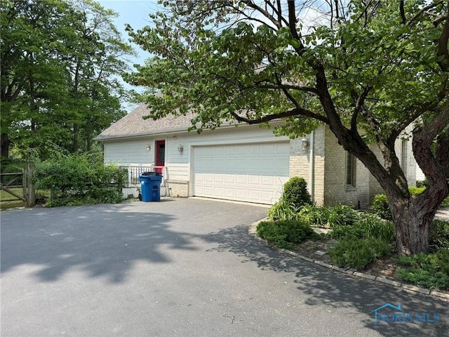 8411 Willow Glen Ct, Holland, OH 43528 - garage with asphalt driveway