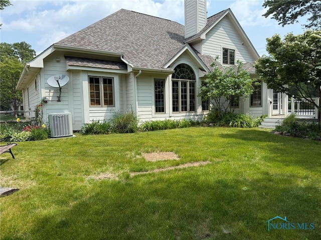 8411 Willow Glen Ct, Holland, OH 43528 - back of property with a chimney, a yard, and a shingled roof