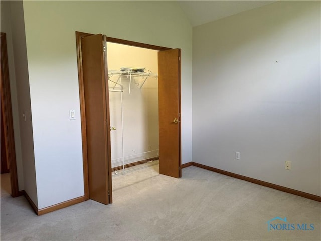 8411 Willow Glen Ct, Holland, OH 43528 - unfurnished bedroom with light colored carpet, lofted ceiling, and a closet