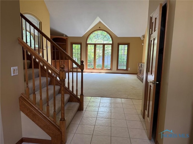 8411 Willow Glen Ct, Holland, OH 43528 - stairs featuring carpet flooring, tile patterned flooring, and vaulted ceiling