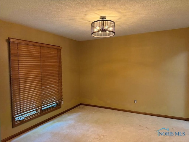 8411 Willow Glen Ct, Holland, OH 43528 - spare room featuring carpet, a textured ceiling, and a chandelier