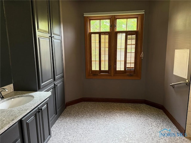 8411 Willow Glen Ct, Holland, OH 43528 - bathroom with vanity and baseboards