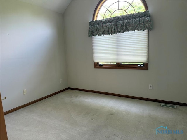 8411 Willow Glen Ct, Holland, OH 43528 - carpeted empty room featuring vaulted ceiling and baseboards