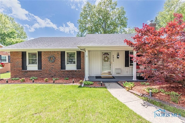 4911 Claradale Rd, Toledo, OH 43614 - view of front of property featuring a porch, a front yard, board and batten siding, and roof with shingles
