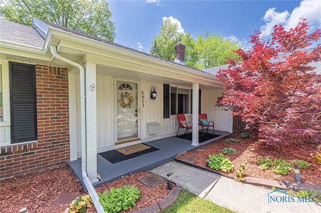 4911 Claradale Rd, Toledo, OH 43614 - entrance to property with brick siding, a porch, and roof with shingles