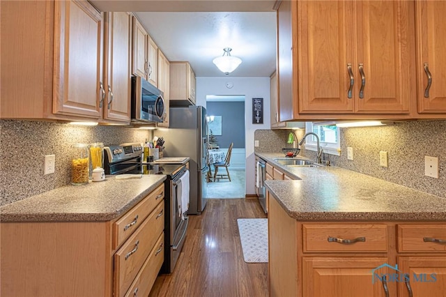 4911 Claradale Rd, Toledo, OH 43614 - kitchen featuring stainless steel appliances, a sink, dark wood finished floors, backsplash, and light stone counters