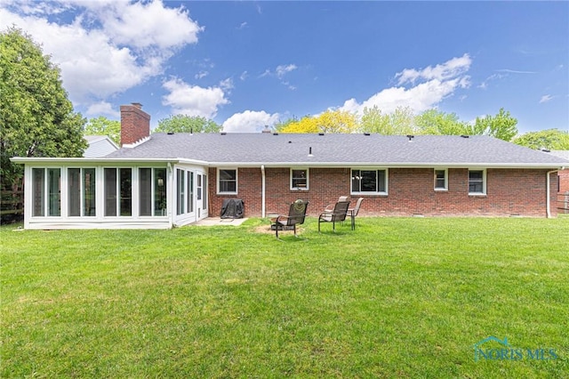 4911 Claradale Rd, Toledo, OH 43614 - rear view of property with brick siding, a sunroom, a lawn, and a chimney