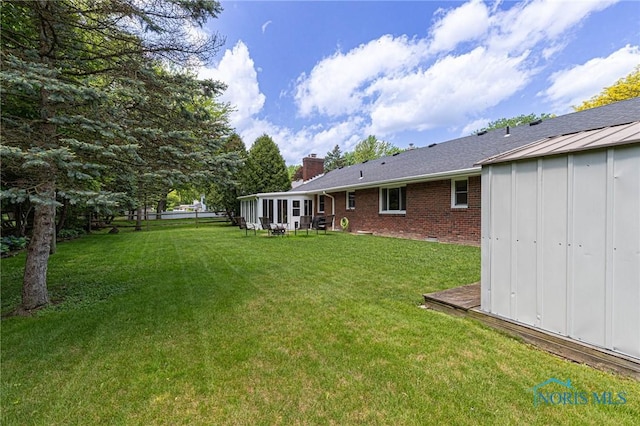 4911 Claradale Rd, Toledo, OH 43614 - view of green lawn featuring a sunroom