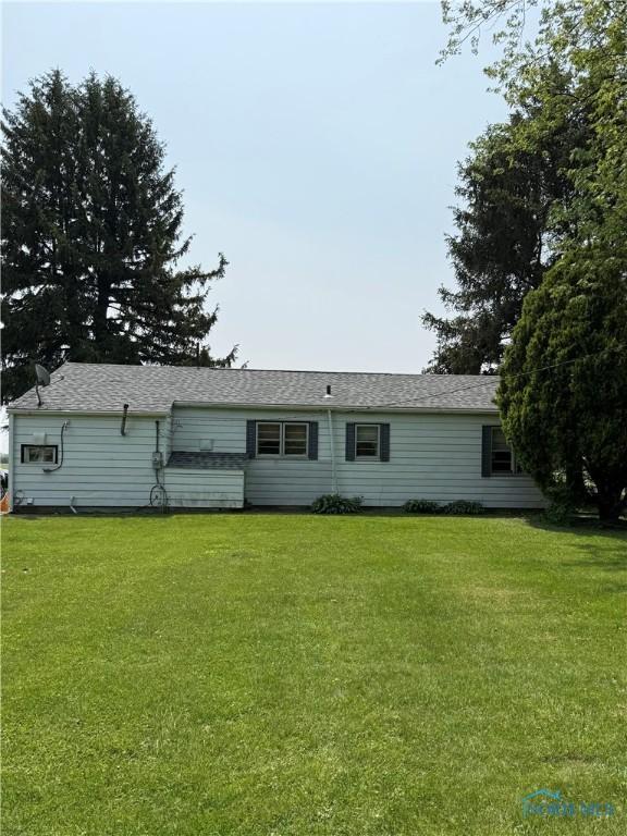 1110 Sandusky St, Fostoria, OH 44830 - view of front of property with a front yard and a shingled roof