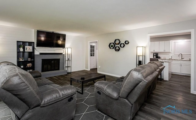510 N Wintergarden Rd, Bowling Green, OH 43402 - living room featuring baseboards, a fireplace, and dark wood-type flooring