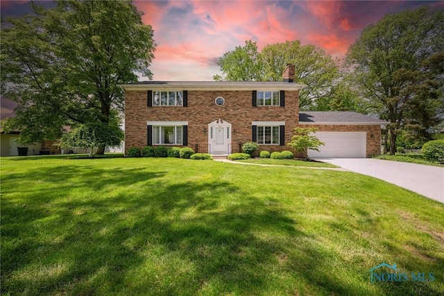 806 Woodstock Ct, Findlay, OH 45840 - colonial-style house with an attached garage, a chimney, driveway, and a yard