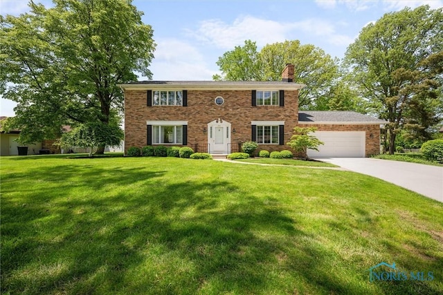 806 Woodstock Ct, Findlay, OH 45840 - colonial house with an attached garage, driveway, a chimney, and a front yard